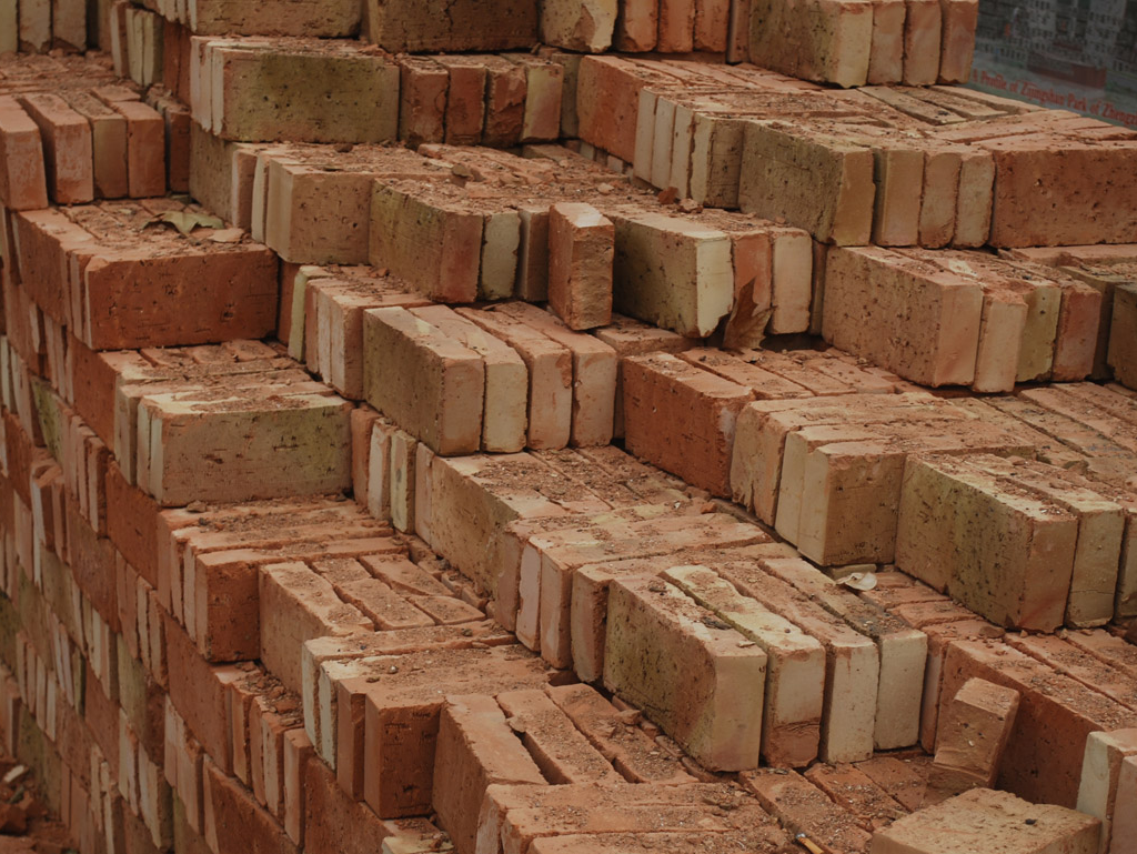 Ideal Supplies with stacks of brick for building many things. Provide concrete.